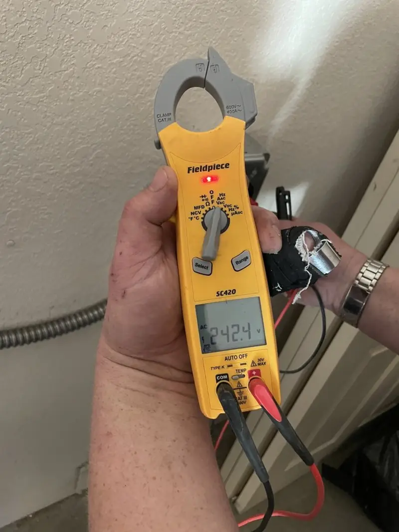 Voltage testing with clamp meter during Whole House Surge Protector in Seymour